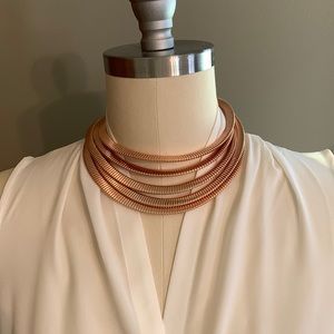 Necklace Five layers Extends to 20”. Metal rose gold color. Lobster claw clasp.